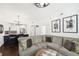 Spacious living room featuring a gray sectional sofa, art, and hardwood floors at 2277 Peachtree Ne Rd # 405, Atlanta, GA 30309