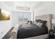 This spacious main bedroom features a tray ceiling, a large window and an upholstered headboard at 2277 Peachtree Ne Rd # 405, Atlanta, GA 30309