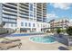 Resort-style pool area featuring a hot tub, lounge chairs, and pergola for relaxation and enjoyment at 2277 Peachtree Ne Rd # 405, Atlanta, GA 30309