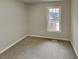 Cozy bedroom with carpeted floor and large window at 368 Sumer Ln, Douglasville, GA 30134