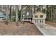 Updated yellow house with a covered porch and driveway, nestled among tall trees at 368 Sumer Ln, Douglasville, GA 30134