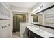 Bathroom featuring a double sink vanity, an updated mirror and shower at 17 Ivy Gates Ne, Atlanta, GA 30342