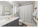 Well-lit bathroom with grey vanity, white countertop and white cabinets above toilet, next to white framed mirror at 1709 Bald Ridge Marina Rd # 4, Cumming, GA 30041