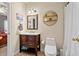 Cozy bathroom with dark wood vanity, round wall décor, and tile flooring at 1709 Bald Ridge Marina Rd # 4, Cumming, GA 30041