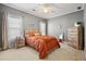 Bright bedroom featuring a wood frame bed, neutral walls, carpet, and natural-colored dressers and bedside tables at 1709 Bald Ridge Marina Rd # 4, Cumming, GA 30041