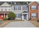 Two-story townhome with gray siding, a blue door, and a small front yard at 1761 Stanwood Nw Dr, Kennesaw, GA 30152