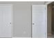 Two white closet doors in a light gray room at 1761 Stanwood Nw Dr, Kennesaw, GA 30152