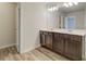 Double vanity bathroom with granite countertop and large mirror at 4331 Portsbrook Ave, Snellville, GA 30039