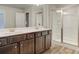 Double vanity bathroom with shower and dark brown cabinets at 4331 Portsbrook Ave, Snellville, GA 30039