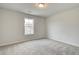 Bright bedroom with gray carpeting and a window at 4331 Portsbrook Ave, Snellville, GA 30039