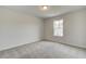 Bright bedroom with gray carpeting and a window at 4331 Portsbrook Ave, Snellville, GA 30039