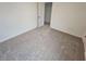 Spacious bedroom with neutral carpet and door to closet at 771 Gelderland Dr, Hampton, GA 30228