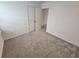 Spacious bedroom with neutral carpeting and double doors leading to a closet at 771 Gelderland Dr, Hampton, GA 30228