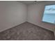 Bright bedroom with a window and neutral carpeting at 771 Gelderland Dr, Hampton, GA 30228