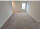 Bright bedroom featuring neutral wall colors and plush carpeting at 771 Gelderland Dr, Hampton, GA 30228