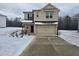 Two-story house with light brick exterior, two-car garage, and snow-covered front yard at 771 Gelderland Dr, Hampton, GA 30228