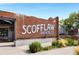 Rustic brick building with the sign 'SCOFFLAW BREWING CO.' is surrounded by green landscaping at 1390 Stirling Nw Cir, Atlanta, GA 30318