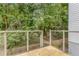 Outdoor deck with metal railing overlooking a private wooded backyard, accessible from sliding glass doors at 1390 Stirling Nw Cir, Atlanta, GA 30318