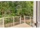 Wooden deck with metal railing overlooking a wooded area at 1390 Stirling Nw Cir, Atlanta, GA 30318