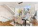 Open-concept dining area with a modern chandelier, large window, and access to the living room at 1390 Stirling Nw Cir, Atlanta, GA 30318