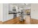 Kitchen area featuring stainless steel appliances, island, white cabinetry, and hardwood floors at 1390 Stirling Nw Cir, Atlanta, GA 30318