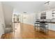 Bright, open kitchen featuring stainless steel appliances, white cabinetry, island, and hardwood floors at 1390 Stirling Nw Cir, Atlanta, GA 30318