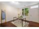 Bright home office featuring a sleek glass desk, large window, and stylish decor elements at 1390 Stirling Nw Cir, Atlanta, GA 30318