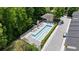 Aerial view of a community pool with lounge chairs surrounded by lush green trees on a sunny day at 1390 Stirling Nw Cir, Atlanta, GA 30318