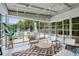 Lounge area with wicker chairs, geometric rug, tiled floor, and pool views through large windows at 1390 Stirling Nw Cir, Atlanta, GA 30318