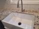 White farmhouse sink with granite countertop and modern faucet at 3123 Oak Dr, Marietta, GA 30066