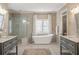 Spa-like bathroom with soaking tub, walk-in shower, and double vanities at 3674 Kingsboro Ne Rd, Atlanta, GA 30319