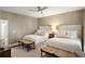 Bright bedroom featuring two beds, neutral tones, and a ceiling fan at 3674 Kingsboro Ne Rd, Atlanta, GA 30319