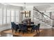 Bright dining room with a large table, blue chairs, and a staircase in the background at 3674 Kingsboro Ne Rd, Atlanta, GA 30319