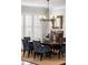 Elegant dining room features a large table, blue chairs, and a beautiful chandelier at 3674 Kingsboro Ne Rd, Atlanta, GA 30319