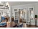 Open dining room with French doors leading to a sunroom and views into the kitchen at 3674 Kingsboro Ne Rd, Atlanta, GA 30319