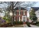 Brick three-story home with stone pathway, landscaping, and a large tree in front at 3674 Kingsboro Ne Rd, Atlanta, GA 30319