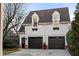 Detached two-car garage with dormer windows and dark garage doors at 3674 Kingsboro Ne Rd, Atlanta, GA 30319