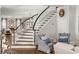 Grand curved staircase with white railings and hardwood floors at 3674 Kingsboro Ne Rd, Atlanta, GA 30319