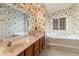 Bathroom with double vanity, bathtub, and floral wallpaper at 415 Rockingham Ln, Woodstock, GA 30189