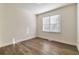 Bright bedroom with hardwood floors and large window at 5506 Sara Creek Ln, Sugar Hill, GA 30518