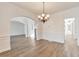 Formal dining room with hardwood floors, chandelier, and wainscoting at 5506 Sara Creek Ln, Sugar Hill, GA 30518