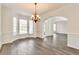 Spacious dining room with hardwood floors, bay window, and chandelier at 5506 Sara Creek Ln, Sugar Hill, GA 30518