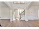 Bright entryway with hardwood floors, high ceilings, and elegant staircase at 5506 Sara Creek Ln, Sugar Hill, GA 30518