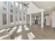 Sunlit great room with wall of windows and kitchen view at 5506 Sara Creek Ln, Sugar Hill, GA 30518