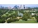 Aerial view of cityscape with lush green park and pond at 1598 W Sussex Ne Rd, Atlanta, GA 30306