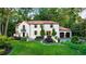 Stunning Spanish-style home with red tile roof, manicured lawn, and mature trees at 1598 W Sussex Ne Rd, Atlanta, GA 30306