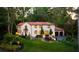 Evening view of charming Spanish-style home with landscape lighting and lush landscaping at 1598 W Sussex Ne Rd, Atlanta, GA 30306