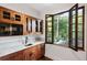 Well-appointed kitchenette with wood cabinetry and a view of the woods at 1598 W Sussex Ne Rd, Atlanta, GA 30306