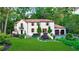 Stunning two-story home featuring a red tile roof, lush landscaping, and a well-manicured front lawn at 1598 W Sussex Rd, Atlanta, GA 30306