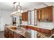 Chef's kitchen with stone countertops, custom cabinets, and natural light from a pass-through window at 1598 W Sussex Rd, Atlanta, GA 30306